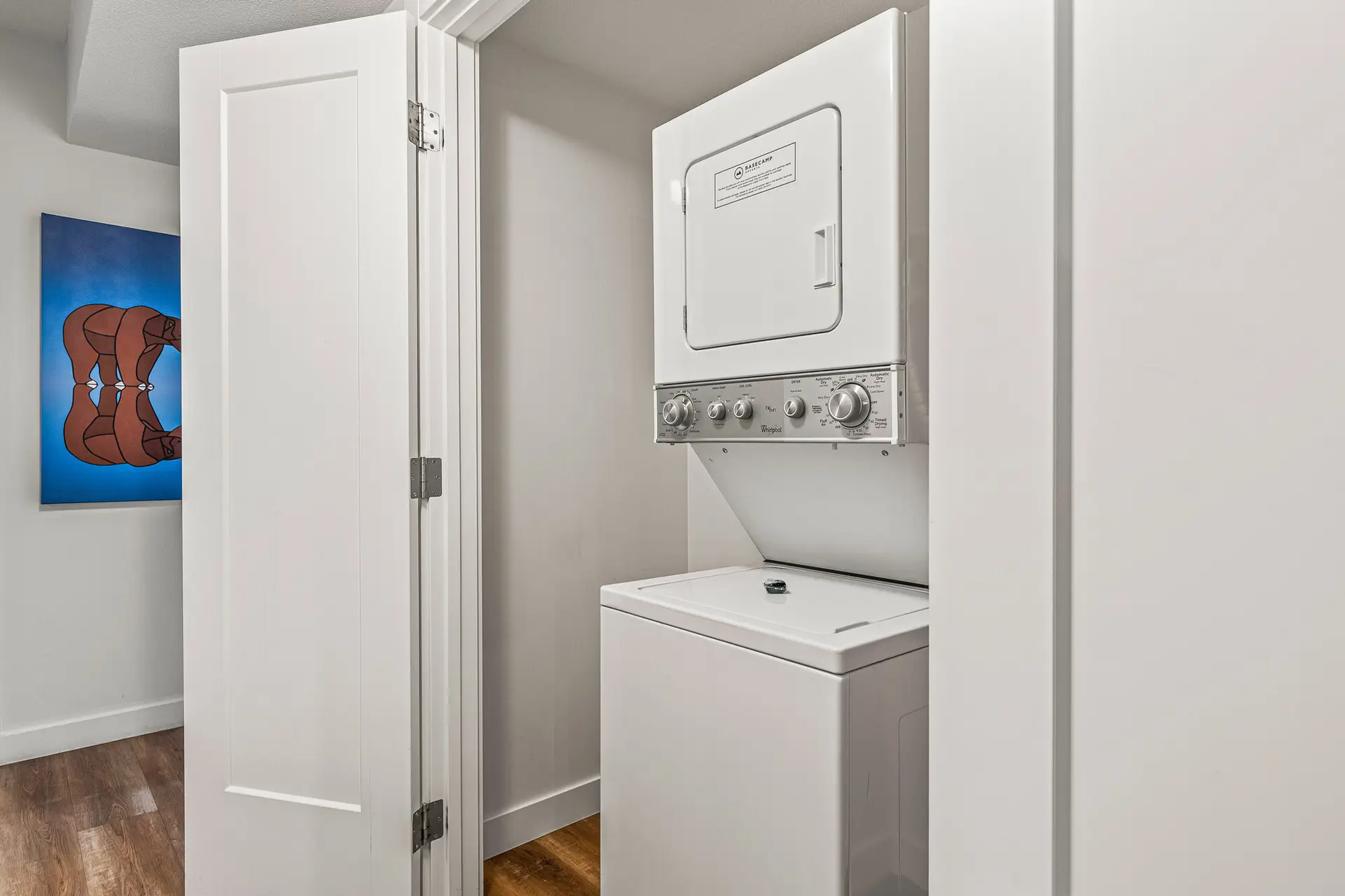 Stackable washer and dryer in a Canmore three-bedroom suite closet