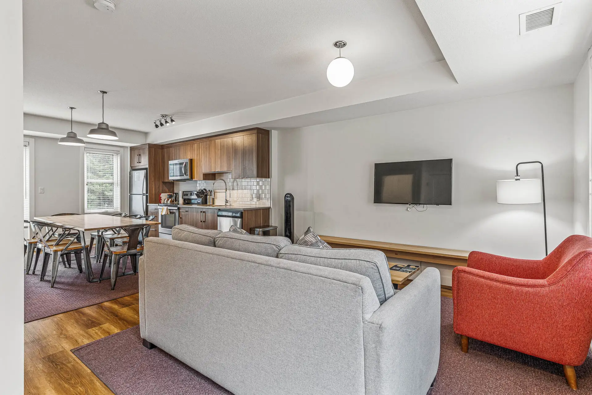 Basecamp Resorts Canmore three-bedroom suite living area with kitchen and dining