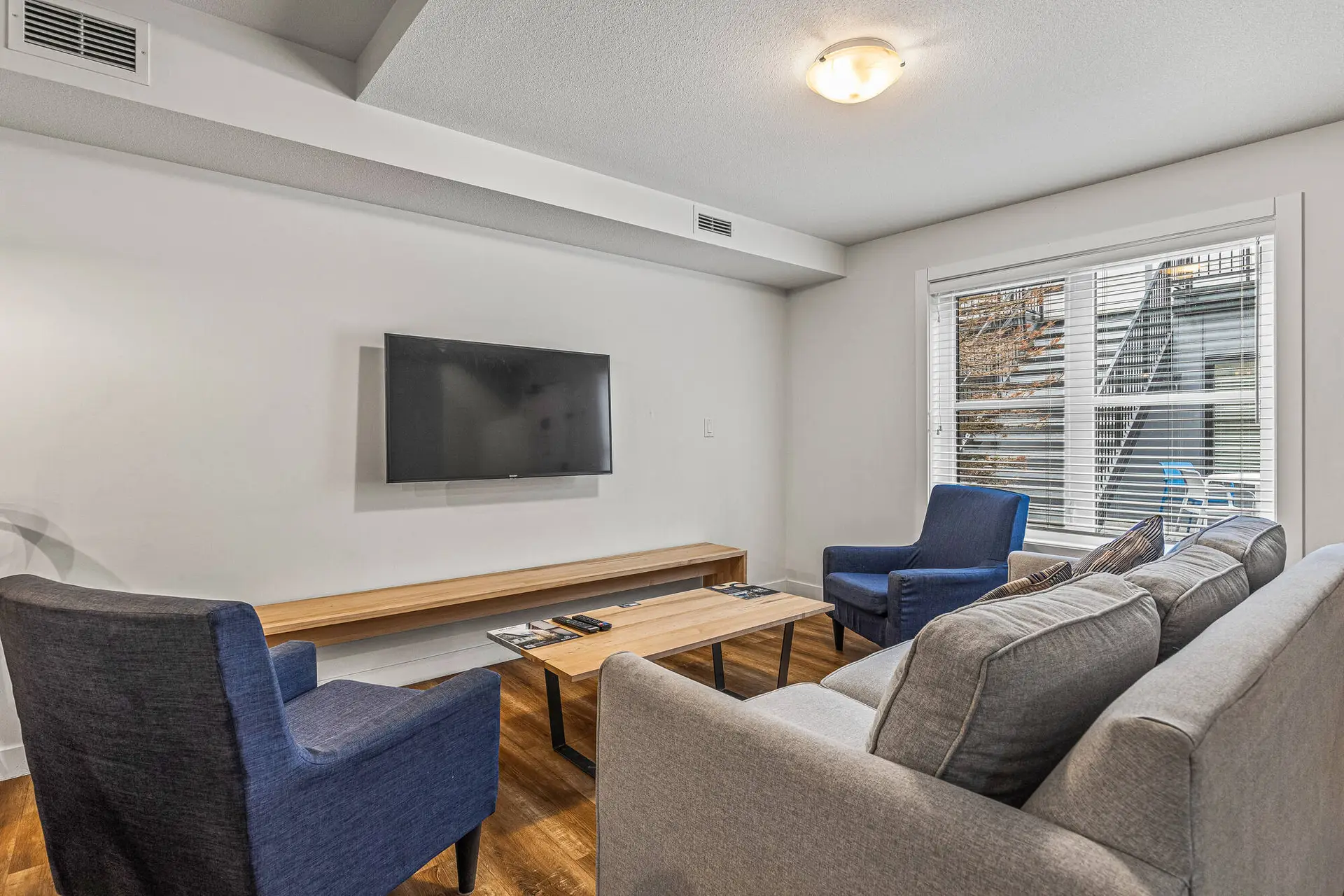 Living room of Basecamp Resorts Canmore three-bedroom suite with seating and TV.