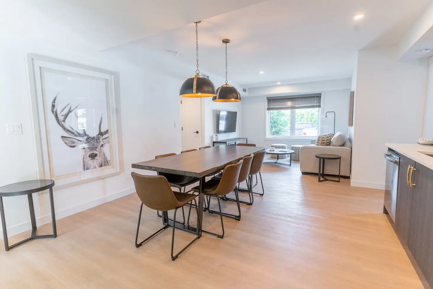 Dining area and living room of a Basecamp Suites Canmore three-bedroom suite.