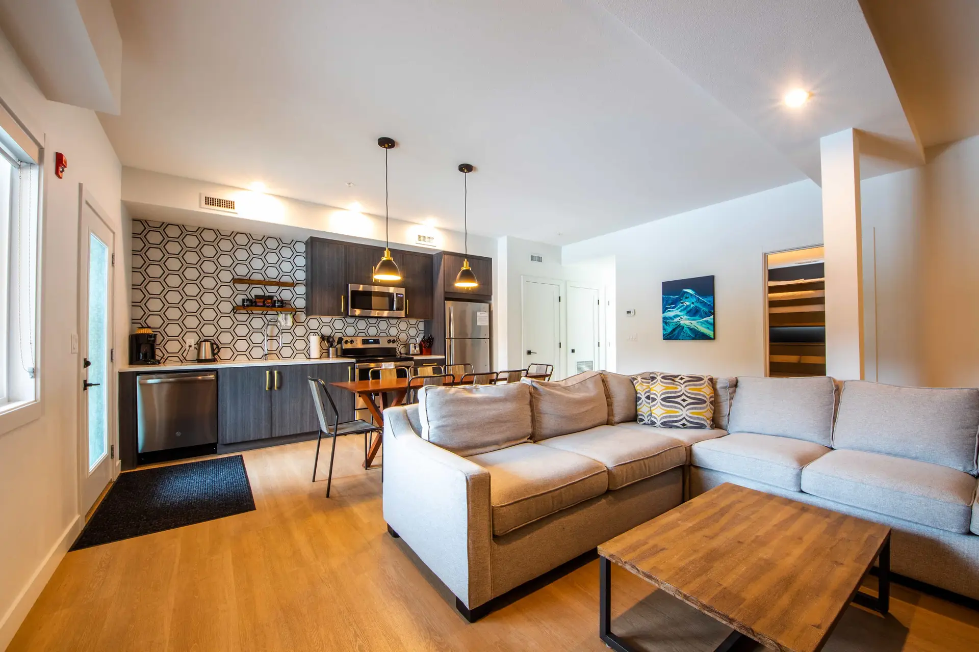 Basecamp Resorts Revelstoke three-bedroom bunk suite living area and kitchen