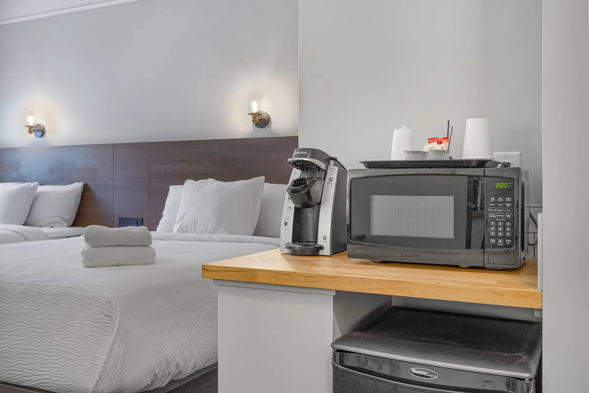 Double Queen room at Basecamp Northwinds Canmore with microwave, coffee maker, and amenities