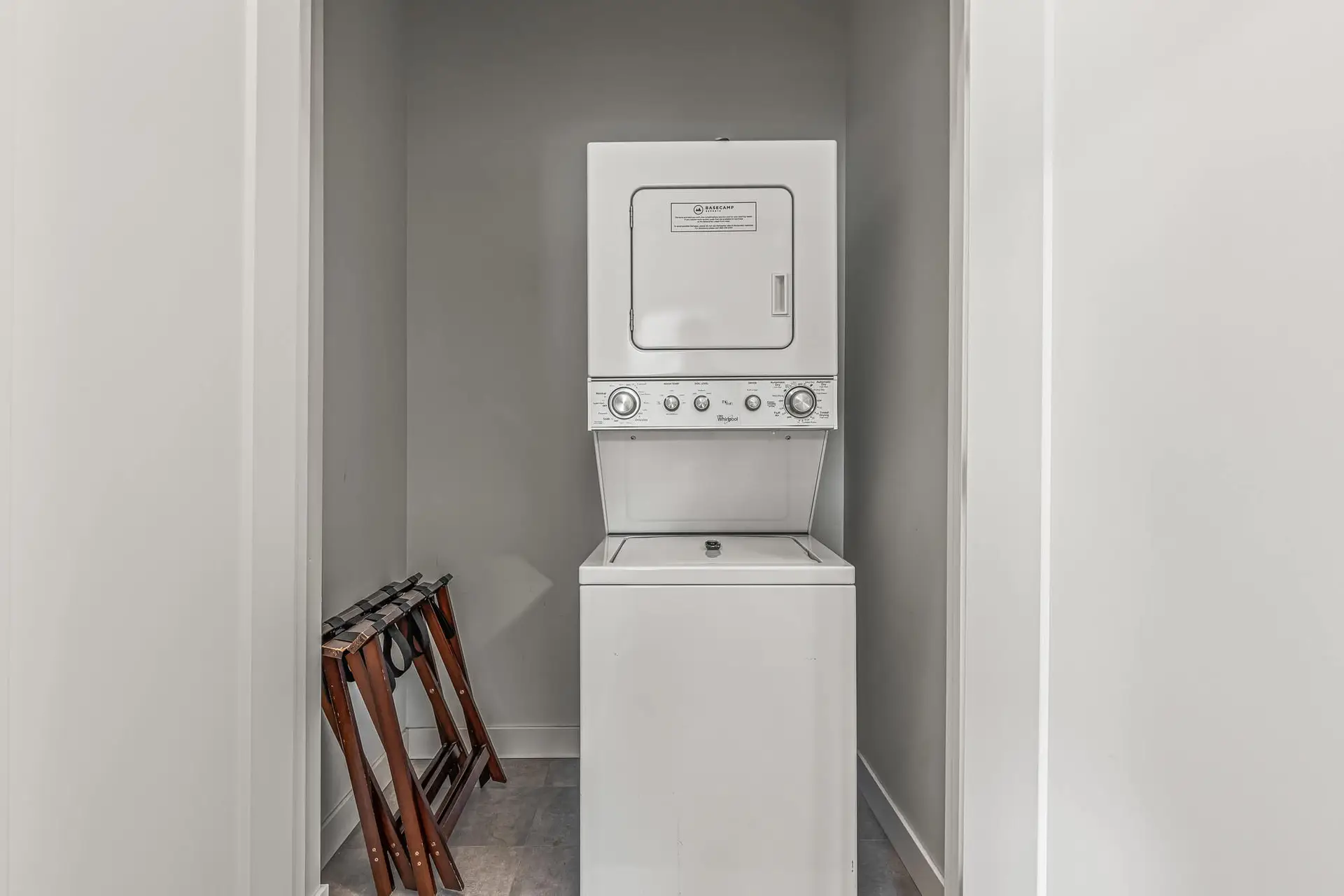 Whirlpool stacked washer and dryer in a laundry closet at Basecamp Resorts Canmore