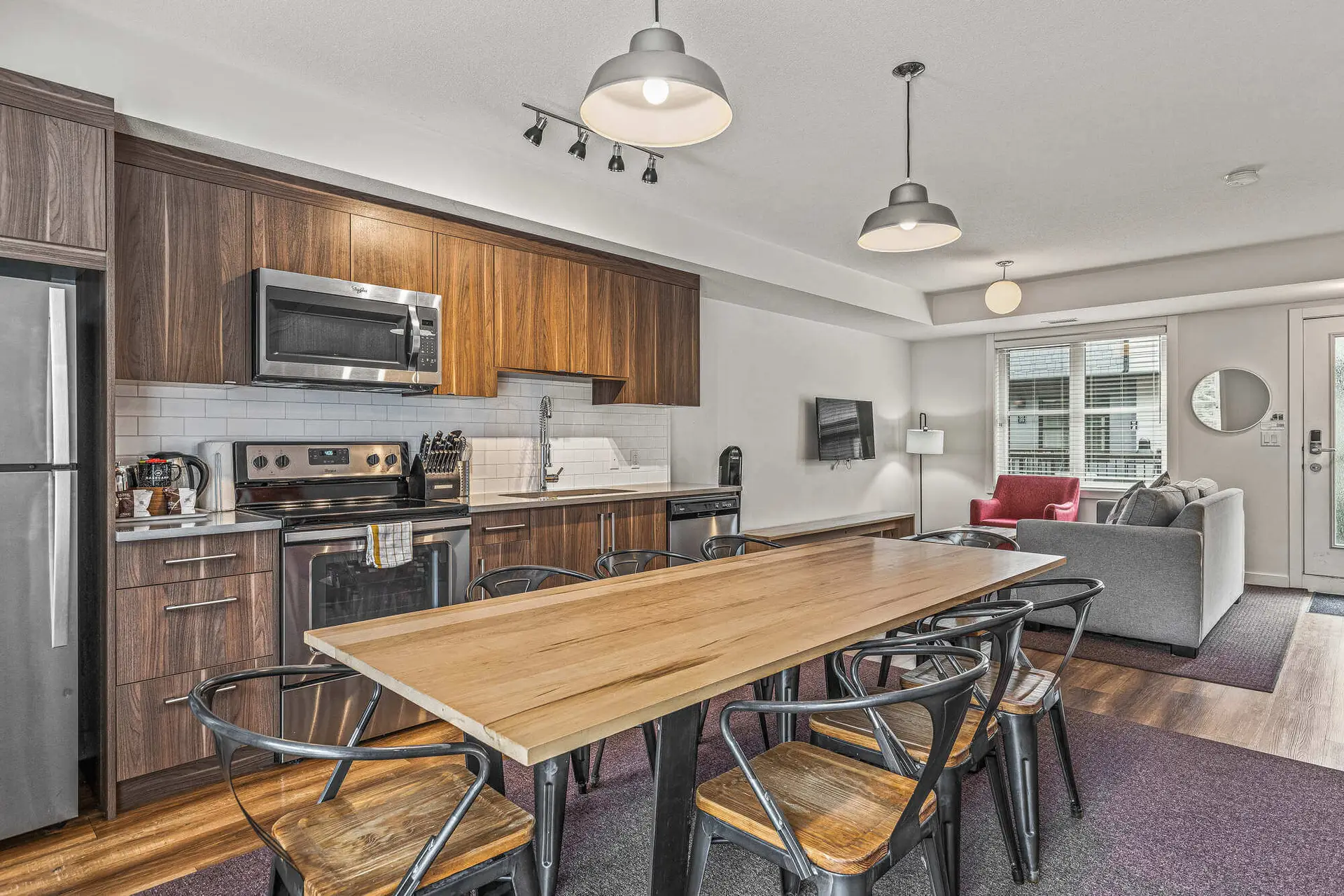 Modern kitchen and dining area in a spacious Basecamp Resorts Canmore suite.