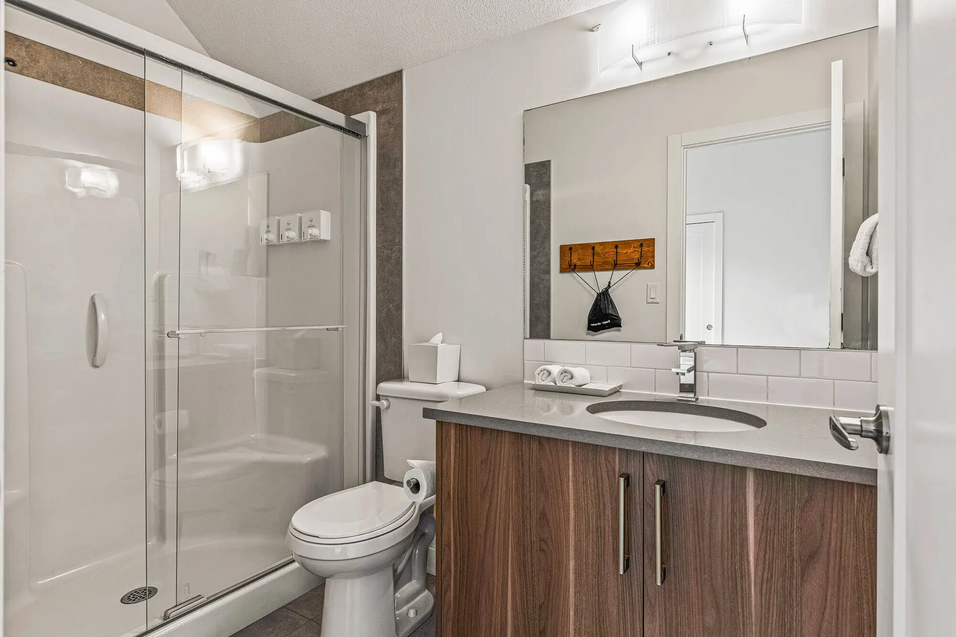 Modern bathroom in Basecamp Resorts Canmore five-bedroom suite with shower and vanity
