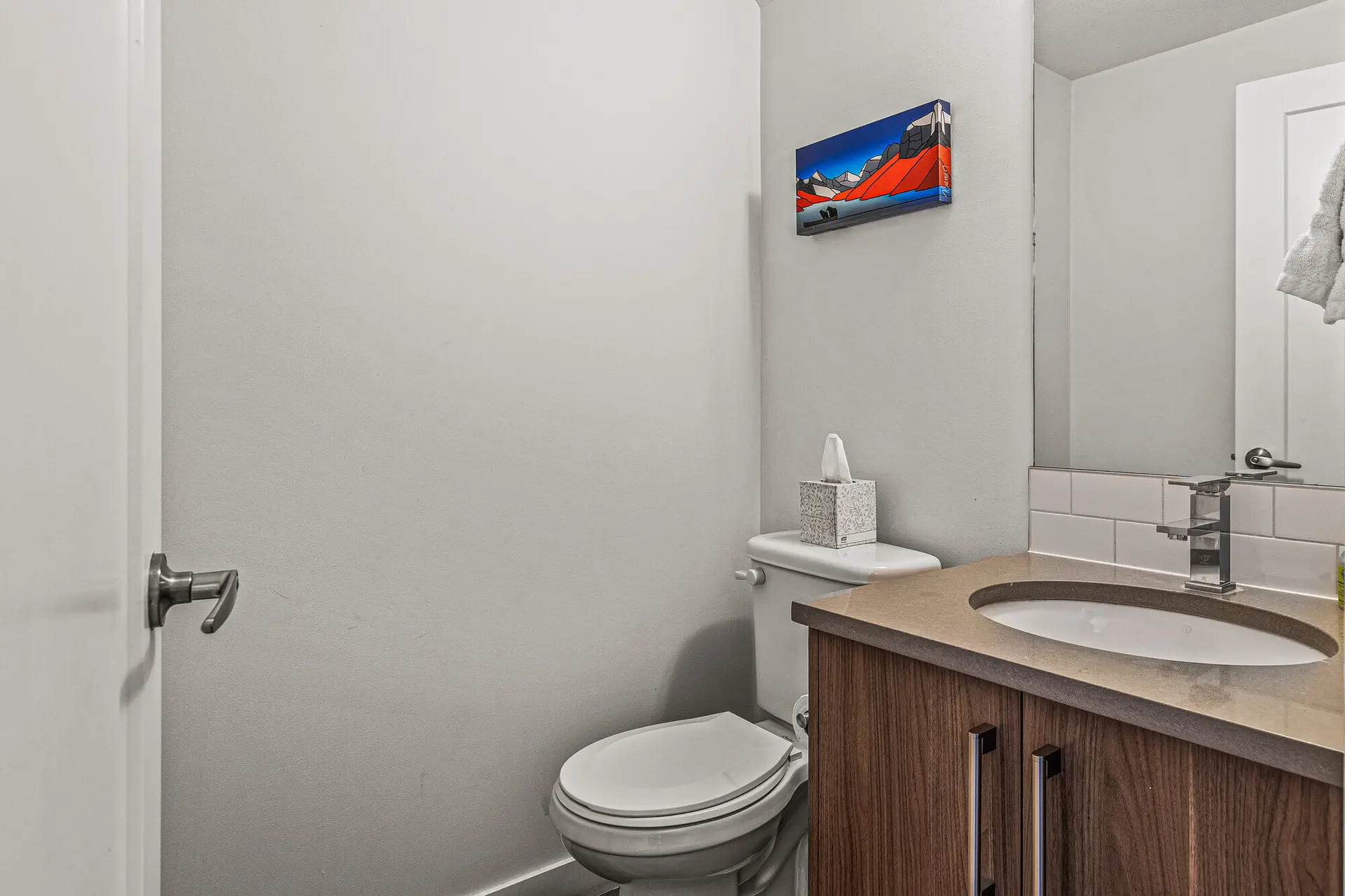 Powder room in Basecamp Resorts Canmore five-bedroom suite with modern vanity.