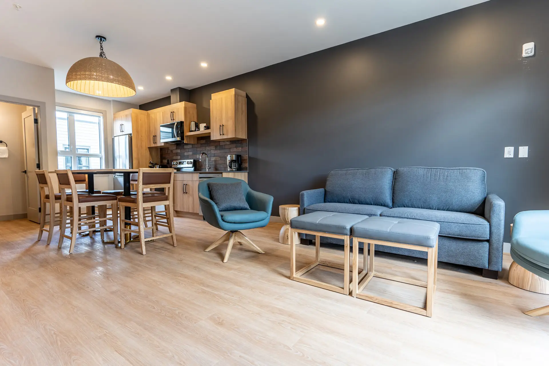 Revelstoke one bedroom suite living area with modern furniture and kitchen