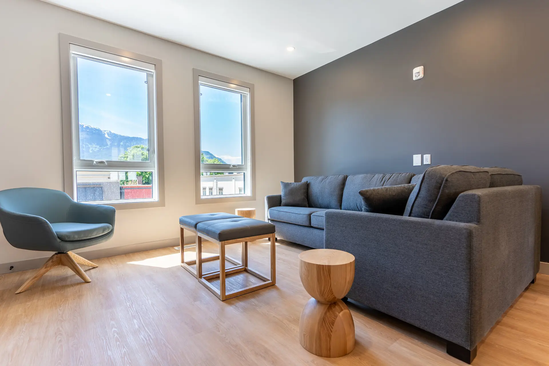 Living room of Basecamp Suites Revelstoke four bedroom suite with modern furniture and mountain views.