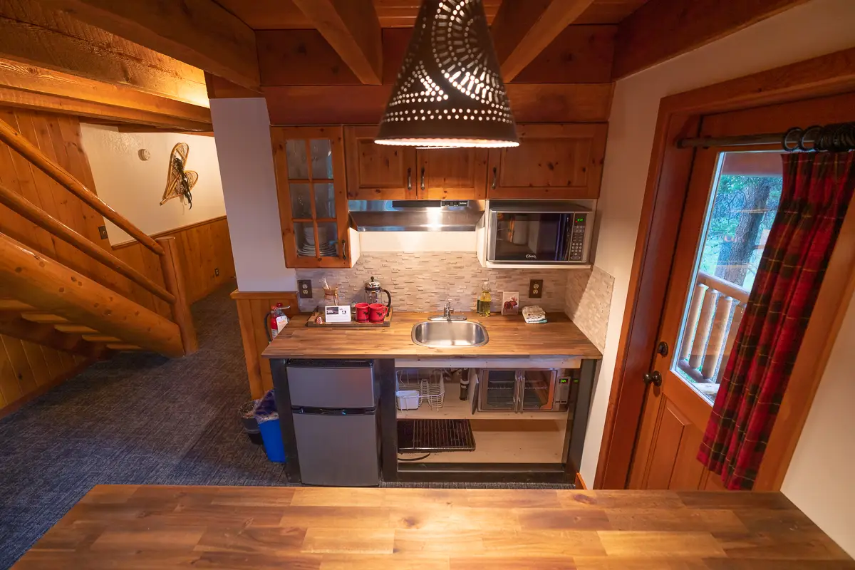 Basecamp Baker Creek Superior Jacuzzi Suite kitchenette with microwave, sink, and mini-fridge.