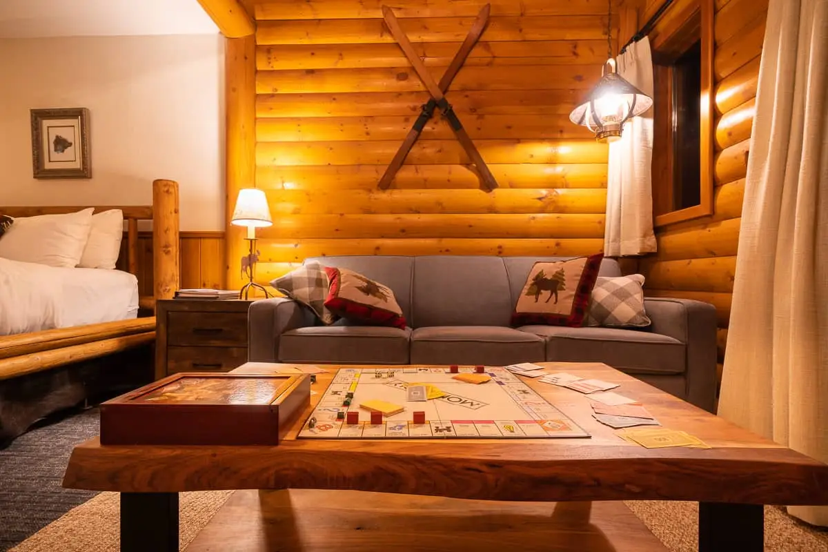Basecamp Baker Creek Jacuzzi Suite living area with sofa, Monopoly board.