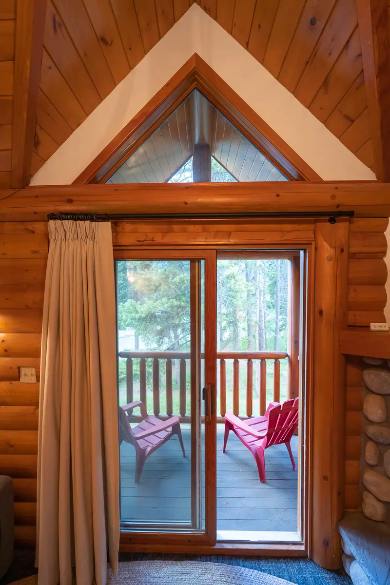 Basecamp Baker Creek Jacuzzi Suite: Deck view through sliding glass doors with red chairs