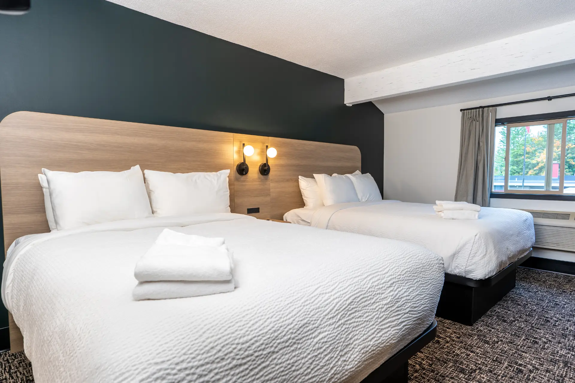 Double Queen room at Basecamp Northwinds Revelstoke with two beds.