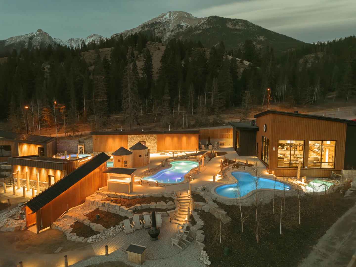 Everwild spa resort at dusk with mountain backdrop
