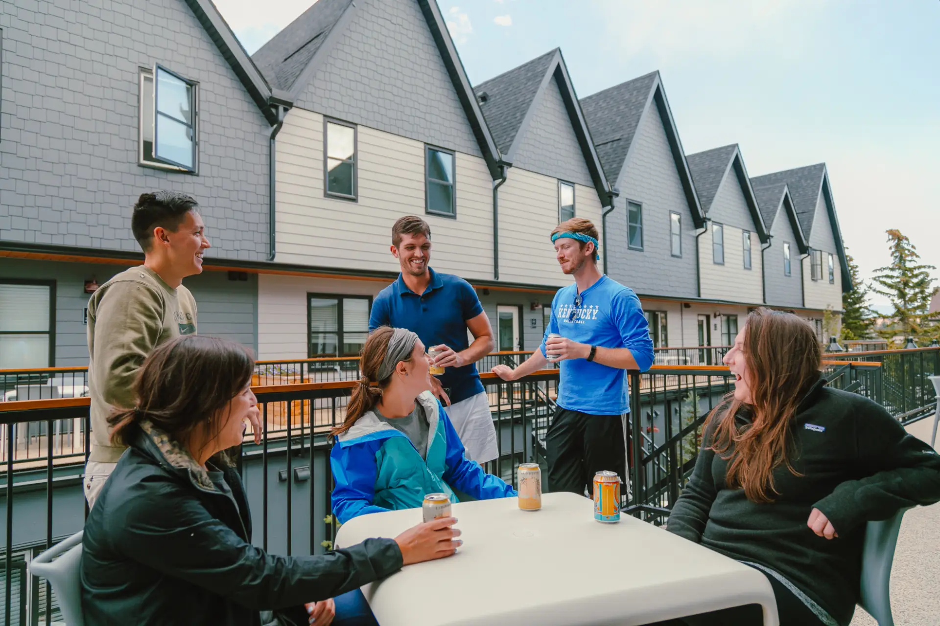 Group of friends enjoying drinks on a resort balcony in Canmore