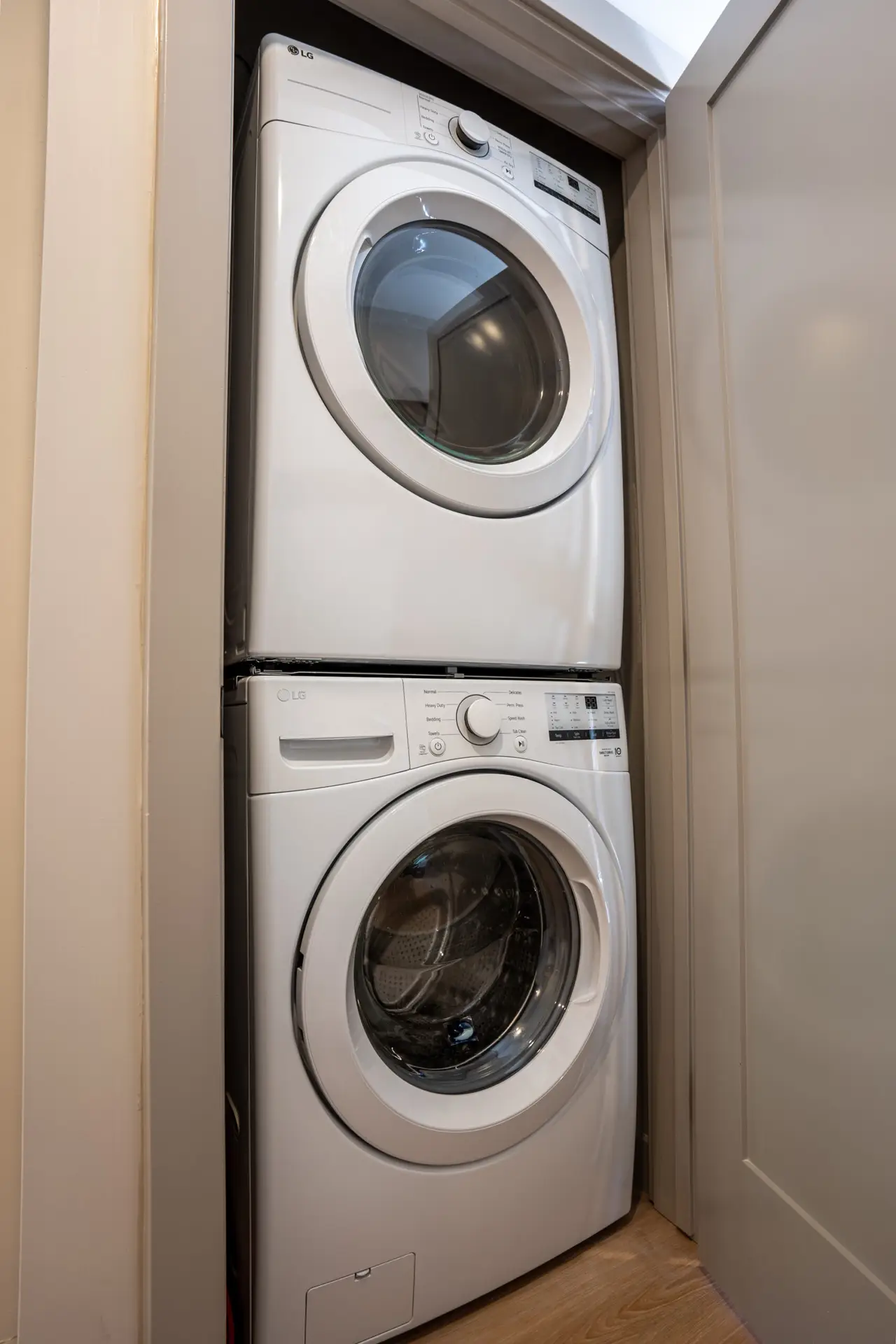 Stackable LG washer and dryer in a Basecamp Suites Revelstoke king suite.