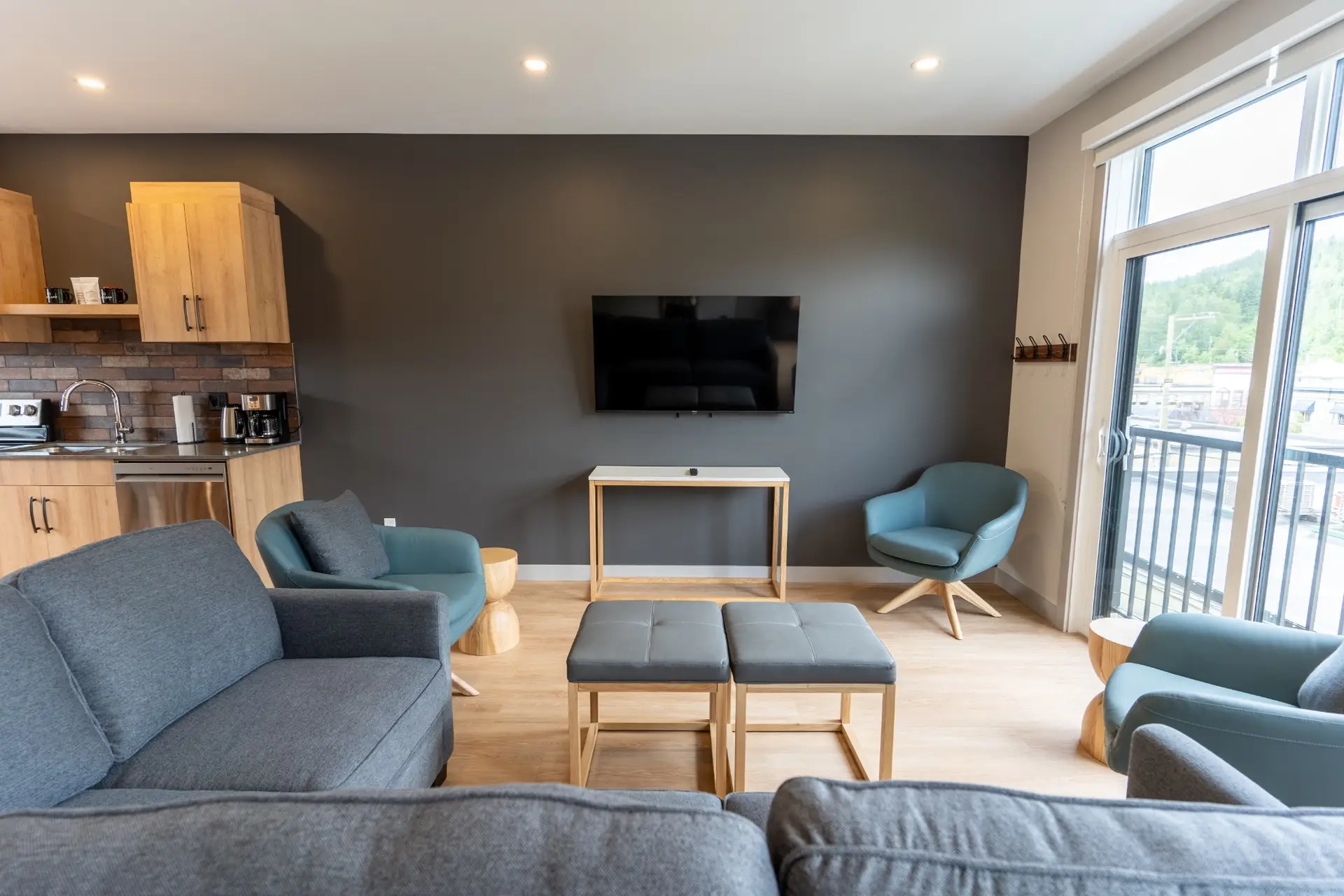 Revelstoke Three Bedroom Suite living room with modern furniture and kitchen