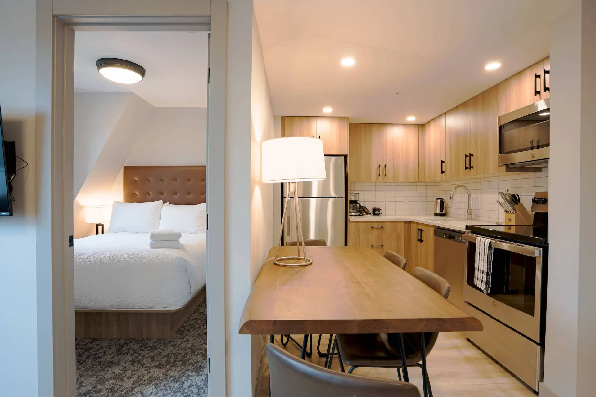Basecamp Suites Banff two-bedroom suite: modern kitchen and cozy bedroom