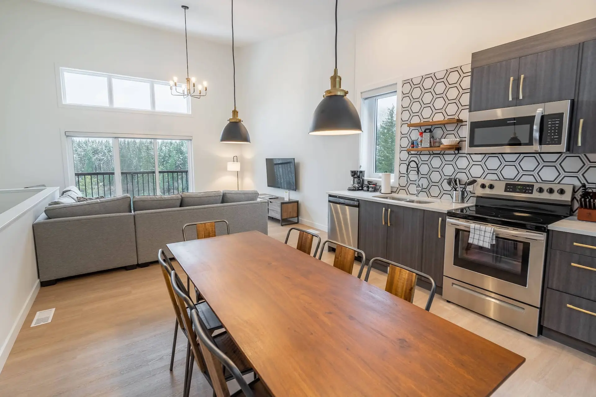 Modern three-bedroom suite living area and kitchen at Basecamp Resorts Revelstoke