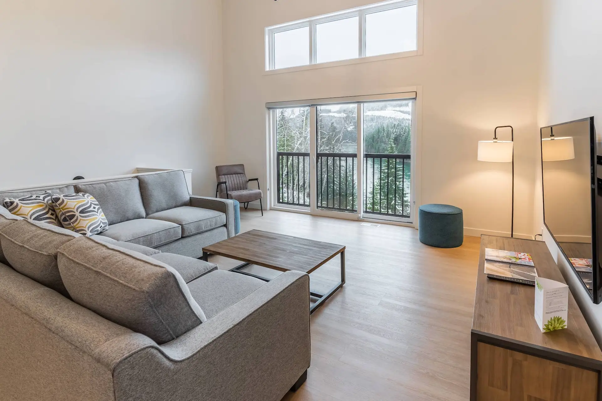 Five-bedroom suite living area at Basecamp Resorts Revelstoke with mountain views.