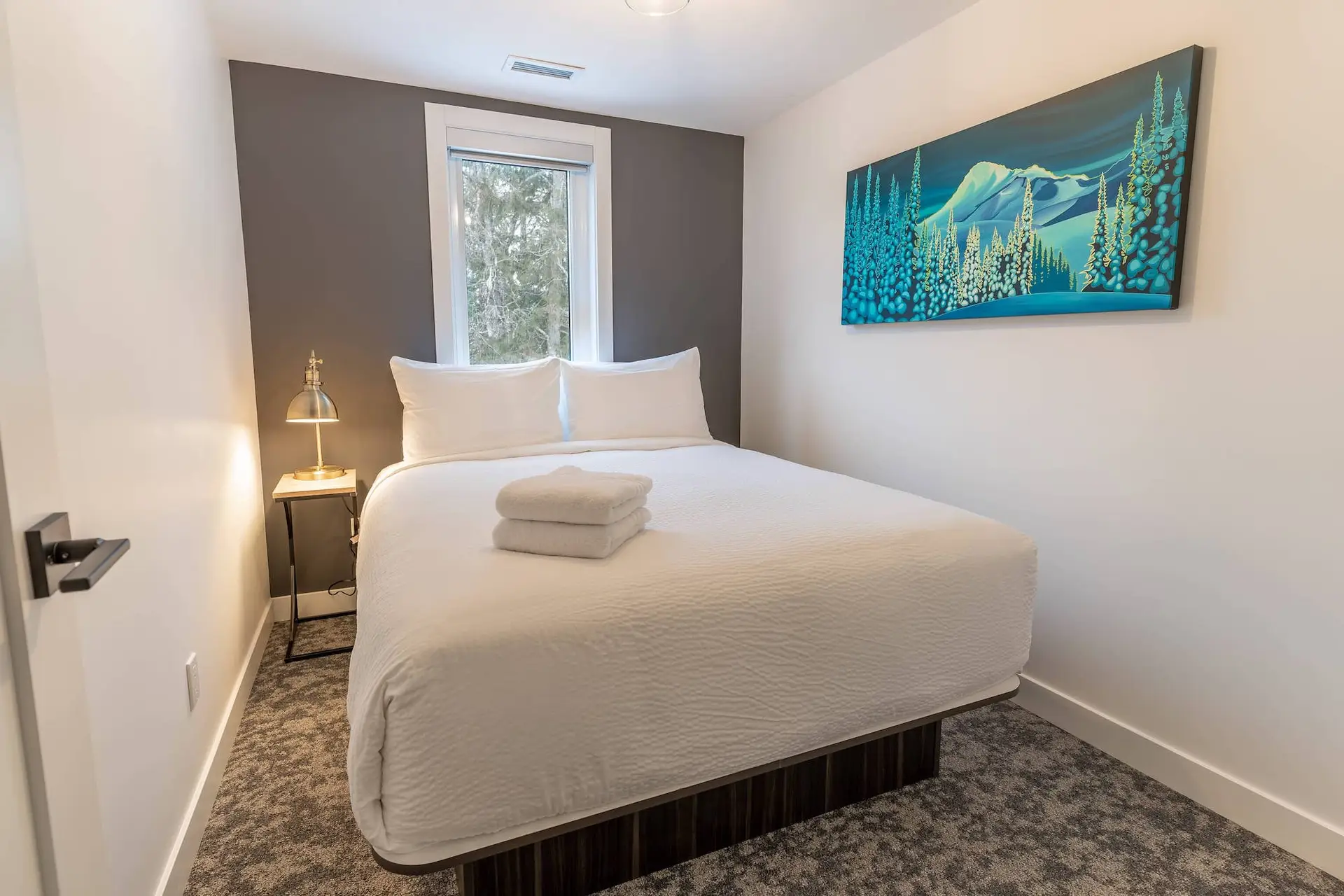 Bedroom in Basecamp Resorts Revelstoke Three Bedroom Suite with mountain art