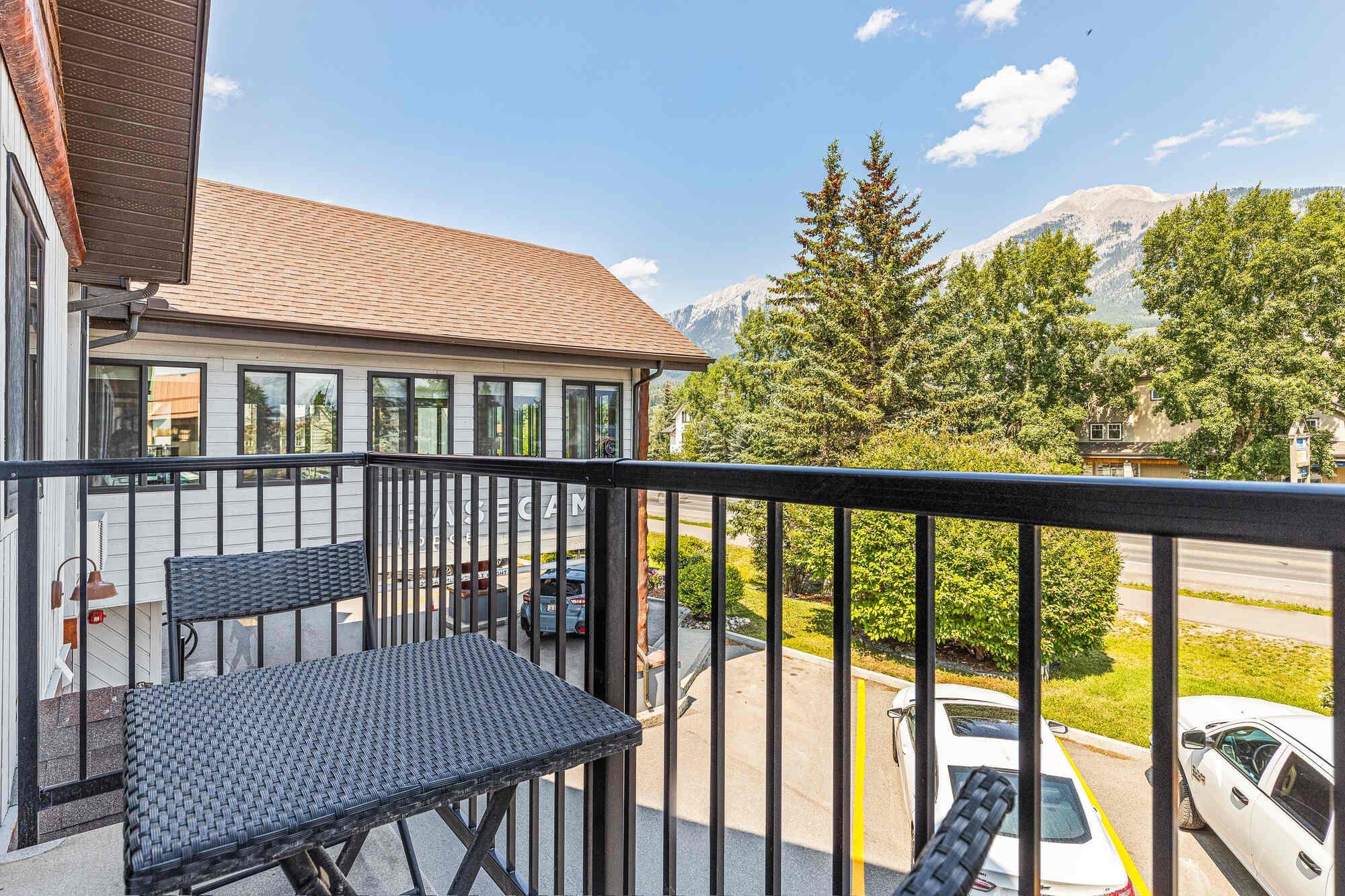 Balcony view from Basecamp Lodge Canmore King Suite with mountains.