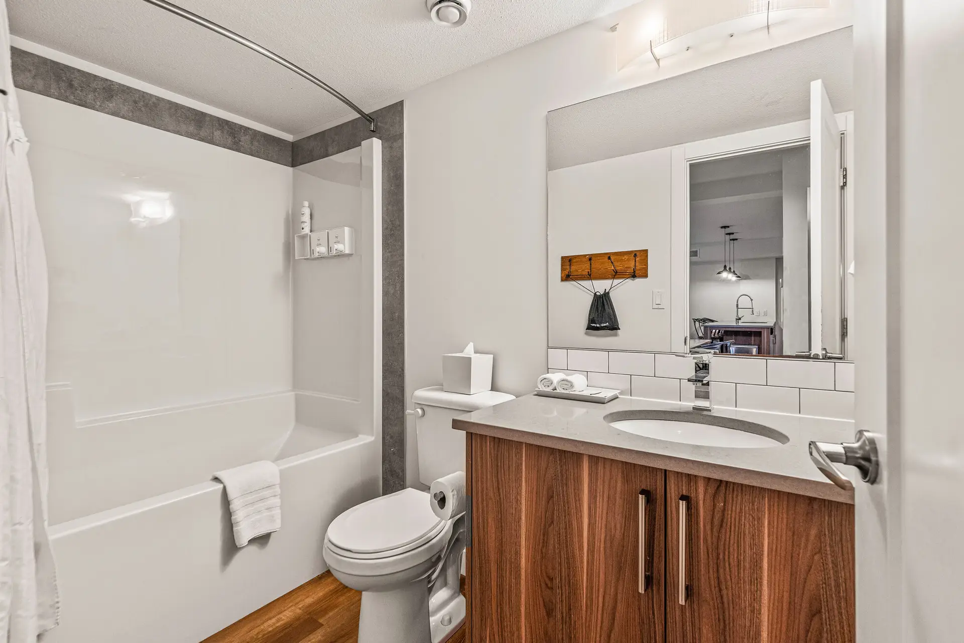 Modern bathroom with bathtub, toilet, and vanity in Basecamp Resorts Canmore suite.