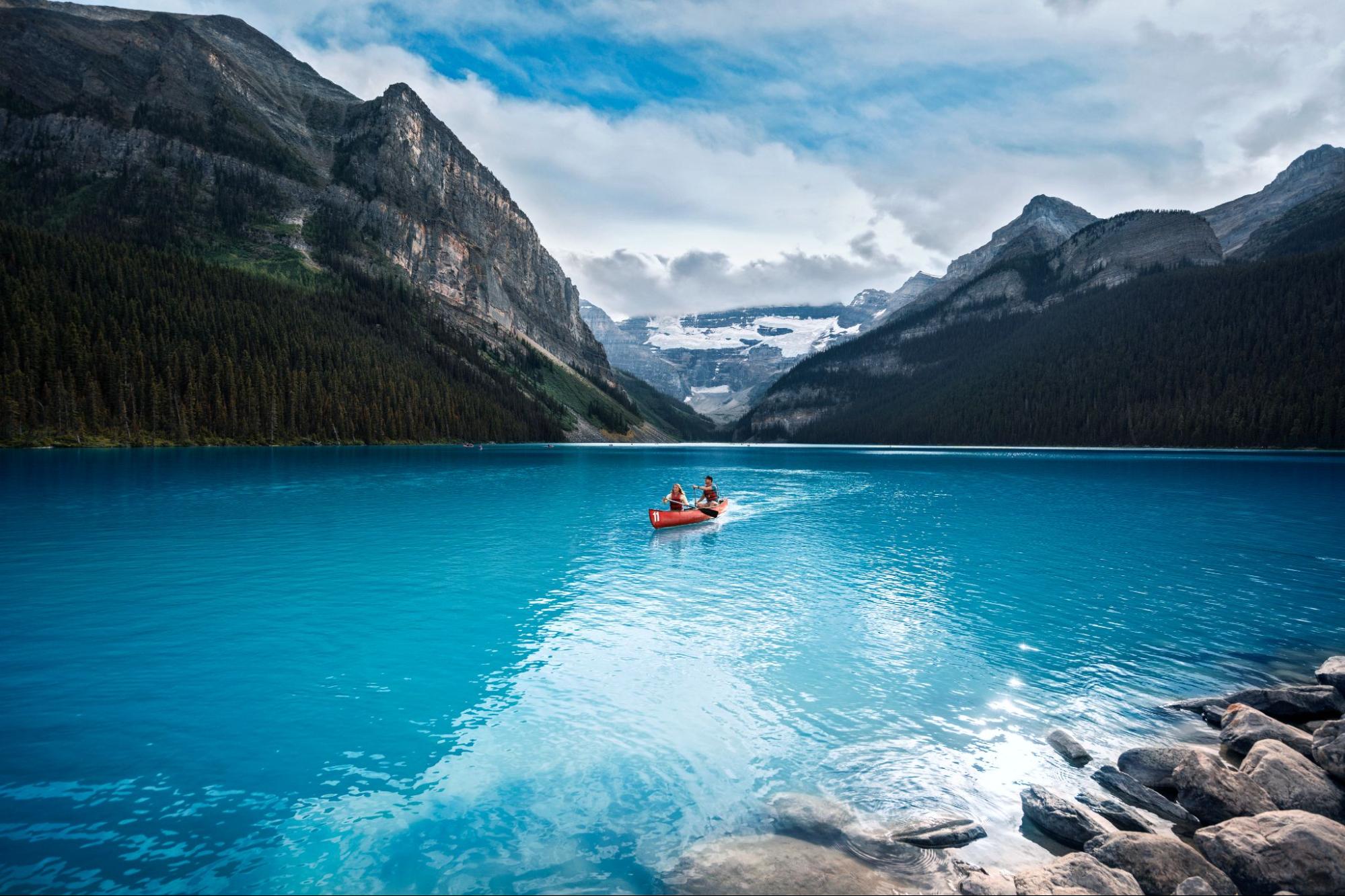 Canoeists enjoy the turquoise waters of Lake Louise, a stunning lake near Banff.