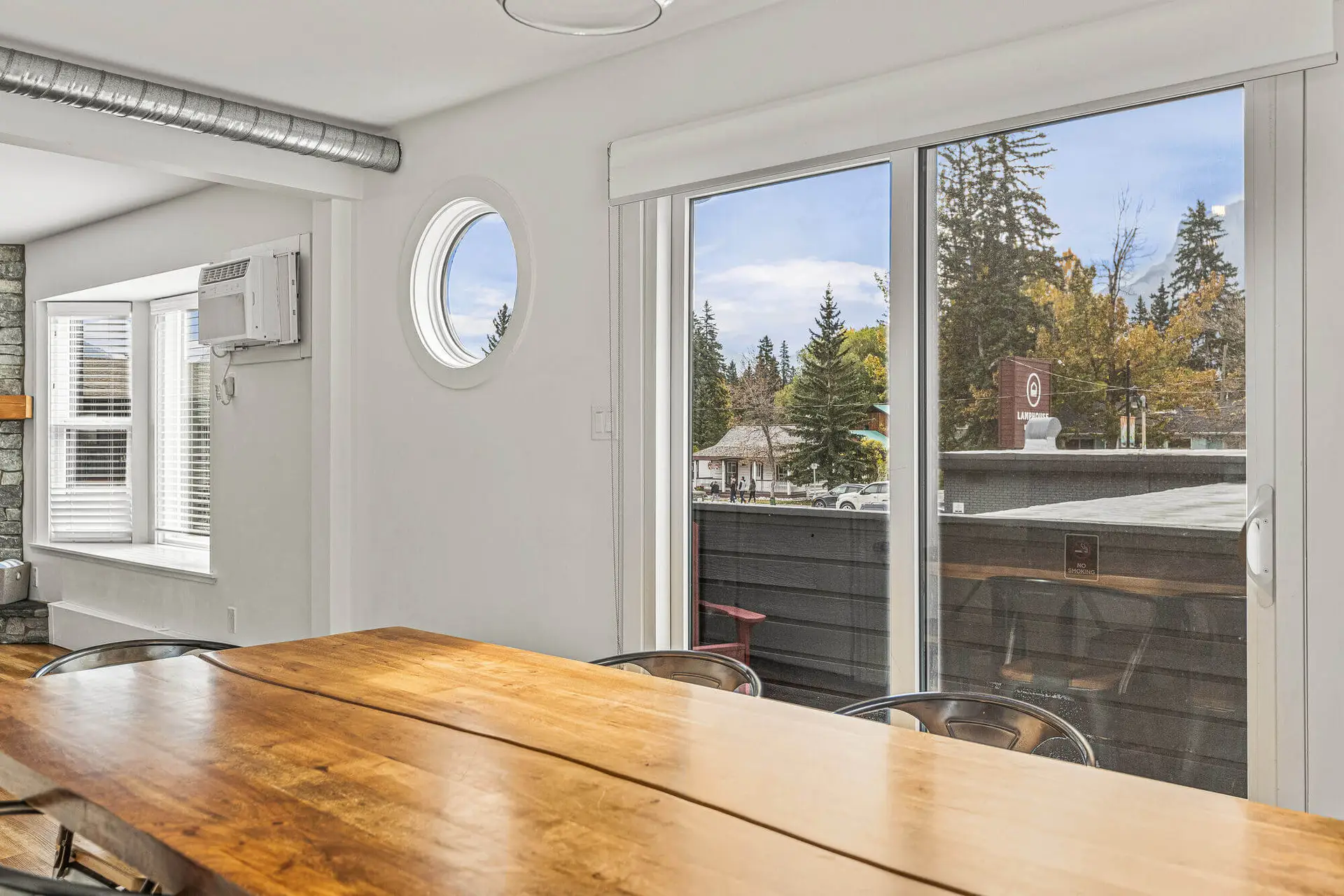 Basecamp Lamphouse Canmore apartment dining table with view of trees and mountains